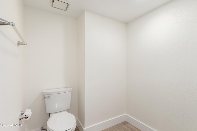 7702 W Piute Ave, Glendale, AZ 85308 - bathroom featuring baseboards, wood finished floors, and toilet
