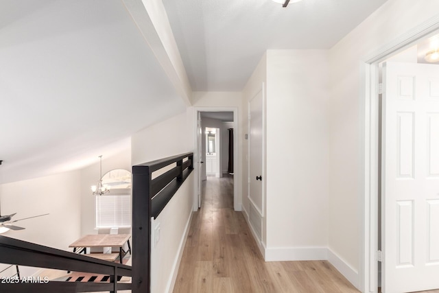 7702 W Piute Ave, Glendale, AZ 85308 - hall featuring light wood-style flooring, a chandelier, and baseboards