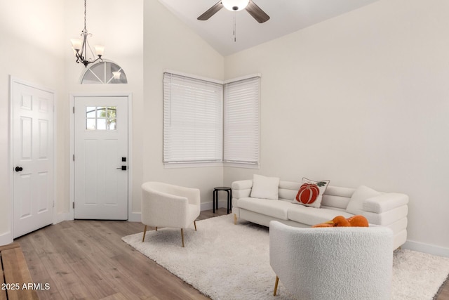 7702 W Piute Ave, Glendale, AZ 85308 - living room featuring a chandelier, wood finished floors, baseboards, a ceiling fan, and high vaulted ceiling