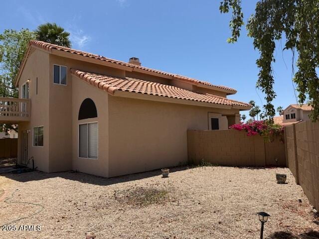 7702 W Piute Ave, Glendale, AZ 85308 - back of house with stucco siding, a tile roof, and a chimney