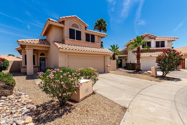 7702 W Piute Ave, Glendale, AZ 85308 - mediterranean / spanish home with an attached garage, driveway, stucco siding, and a tiled roof