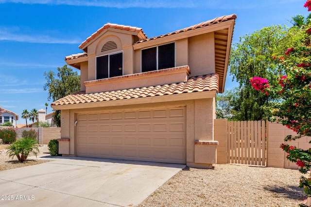 7702 W Piute Ave, Glendale, AZ 85308 - mediterranean / spanish-style home featuring a tiled roof, stucco siding, a garage, and a gate