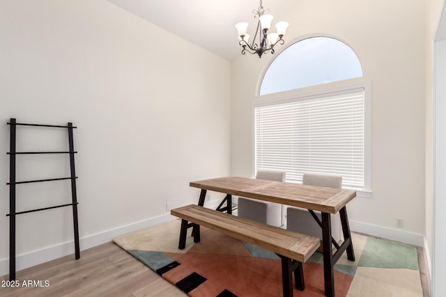 7702 W Piute Ave, Glendale, AZ 85308 - dining area featuring a chandelier, healthy amount of natural light, light wood finished floors, baseboards, and vaulted ceiling