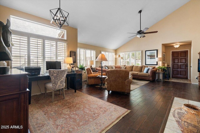 interior space with wood-type flooring, high vaulted ceiling, and ceiling fan with notable chandelier