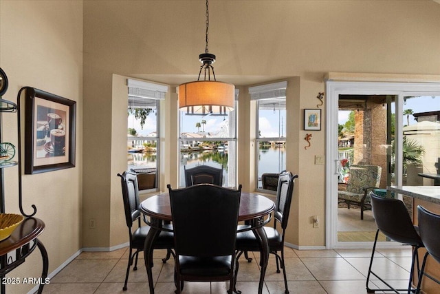 dining area with baseboards and light tile patterned floors