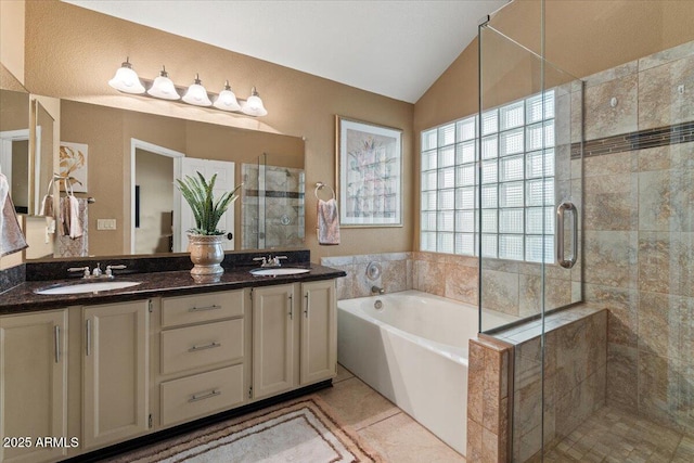 full bathroom with vaulted ceiling, a sink, a bath, and a shower stall