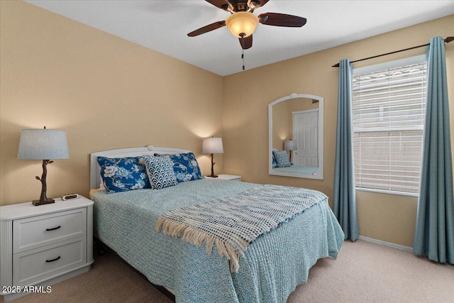 bedroom featuring a ceiling fan, light carpet, and baseboards