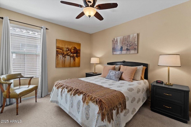 bedroom with ceiling fan, multiple windows, baseboards, and light colored carpet