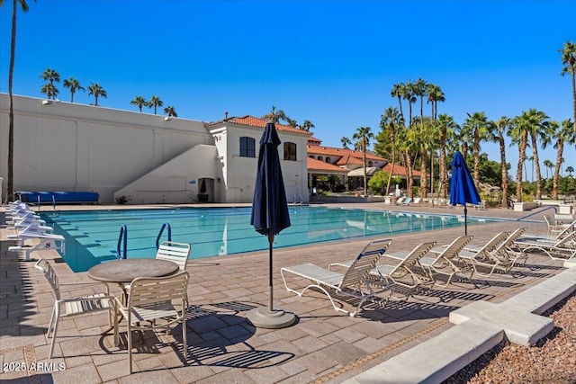 community pool with a patio area