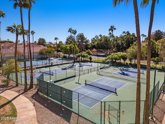 view of tennis court featuring fence