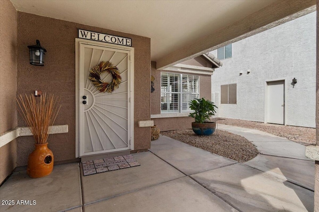 entrance to property with stucco siding