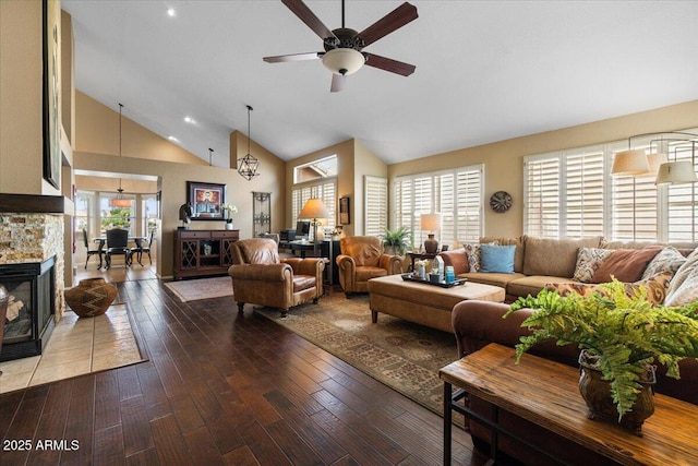 living room with ceiling fan, a fireplace, high vaulted ceiling, and hardwood / wood-style floors