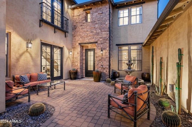 view of patio / terrace with a balcony and french doors