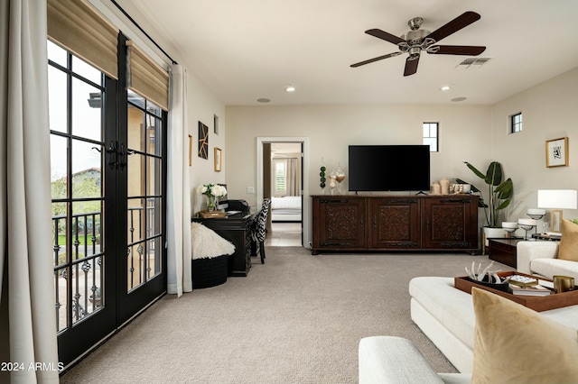 living room with ceiling fan, french doors, and light colored carpet