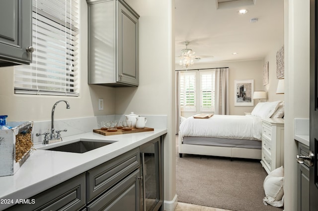 carpeted bedroom featuring sink and wine cooler