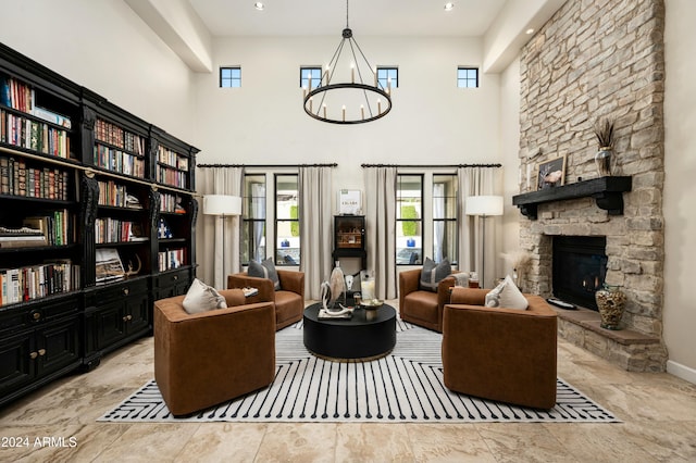 sitting room featuring a fireplace and a towering ceiling