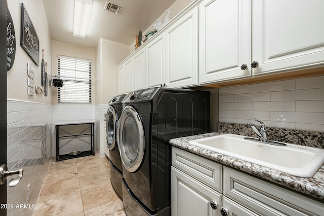 laundry area with cabinets, sink, and washing machine and dryer