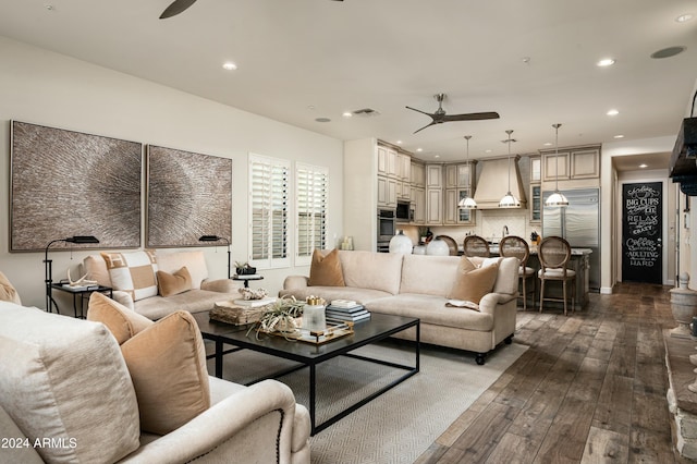 living room featuring ceiling fan and dark hardwood / wood-style flooring