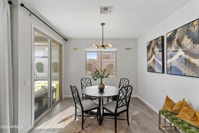 dining room featuring a notable chandelier and light wood-type flooring