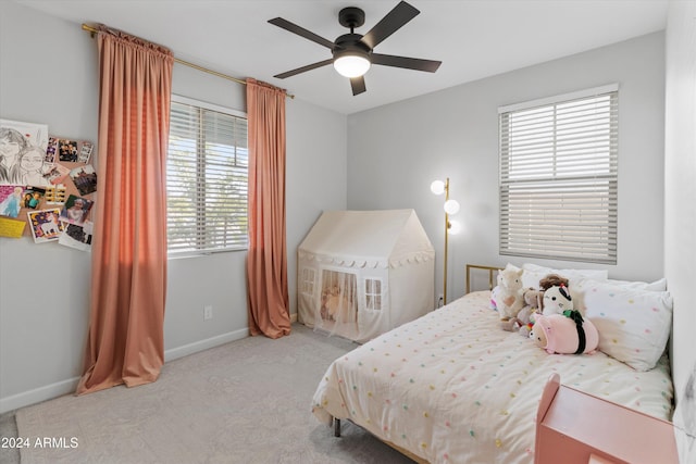 bedroom featuring light colored carpet and ceiling fan