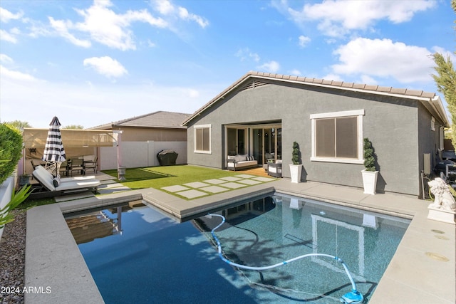 view of pool with an outdoor living space and a patio area