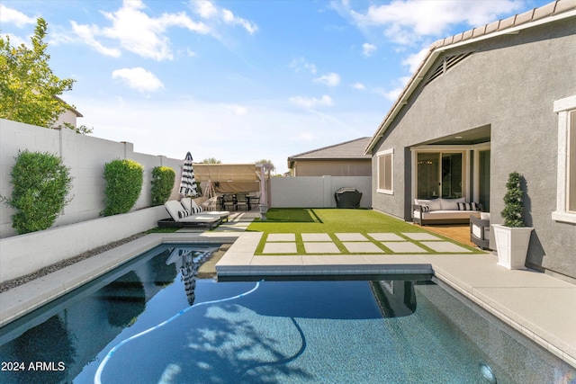 view of swimming pool with an outdoor living space and a patio area