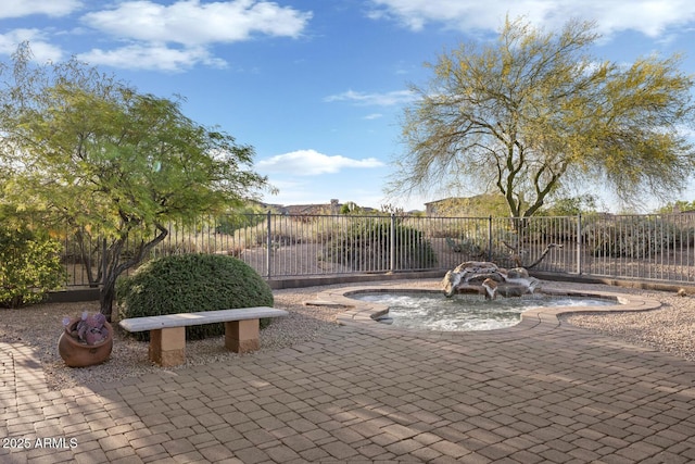 view of patio / terrace featuring fence and a jacuzzi