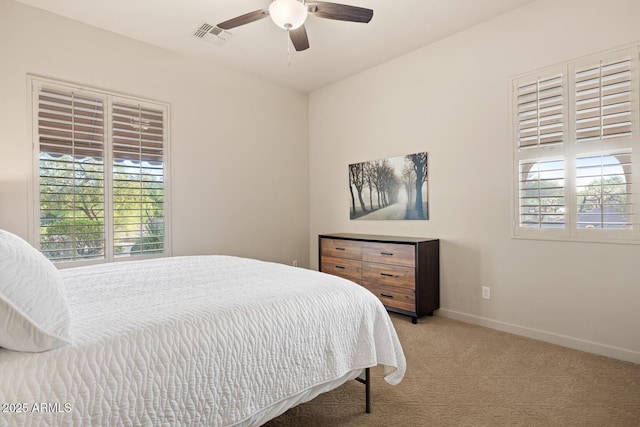carpeted bedroom with baseboards, ceiling fan, and visible vents