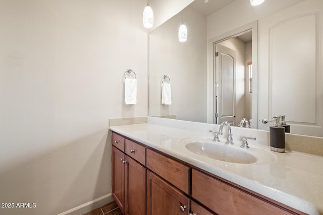 bathroom featuring baseboards, tile patterned floors, and vanity