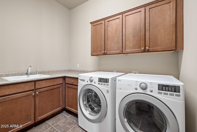 washroom with cabinet space, independent washer and dryer, tile patterned floors, and a sink