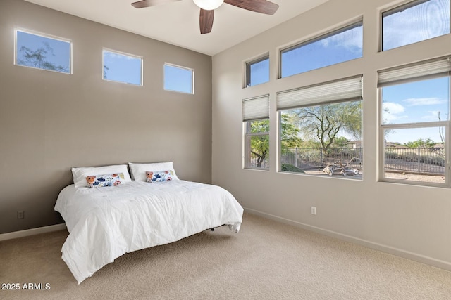 bedroom with baseboards, ceiling fan, and carpet