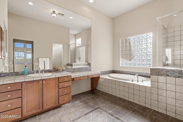 bathroom with a garden tub, visible vents, tile patterned flooring, vanity, and recessed lighting