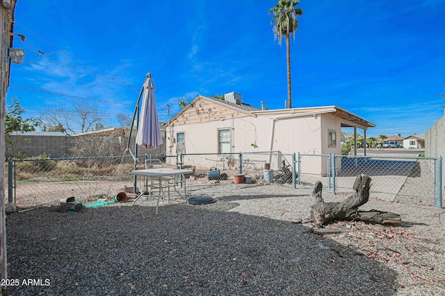 rear view of house with a patio area and fence