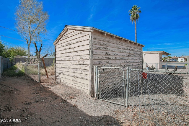 view of outdoor structure with fence and a gate