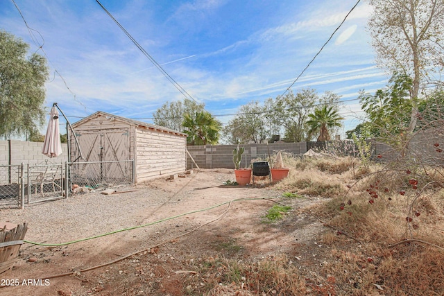 view of yard with a fenced backyard, an outbuilding, and a shed