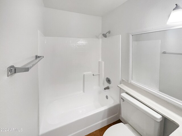 bathroom with toilet and shower / bathing tub combination