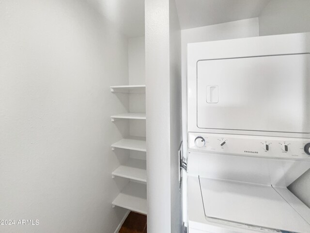 clothes washing area featuring stacked washer / drying machine