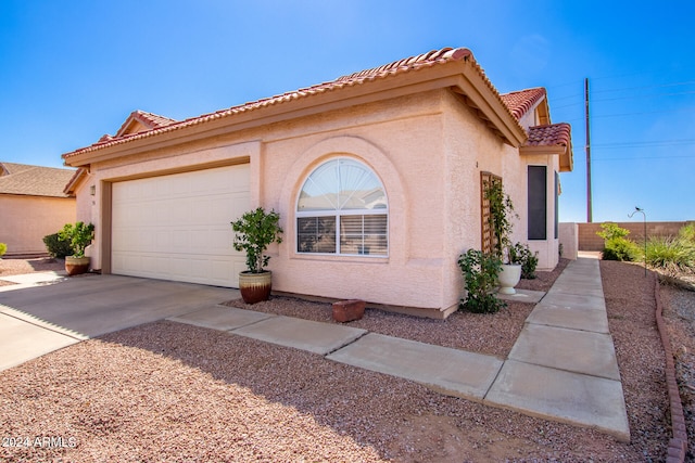 mediterranean / spanish-style house featuring a garage