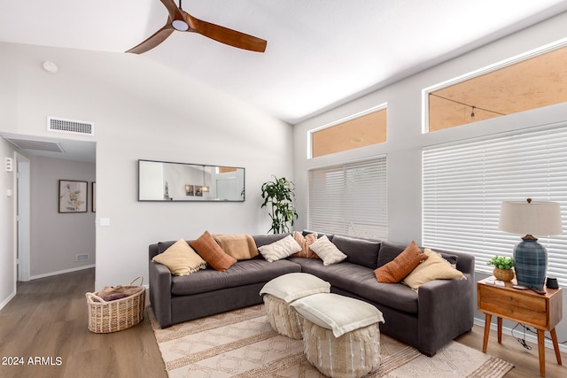 living room with ceiling fan, hardwood / wood-style floors, and high vaulted ceiling