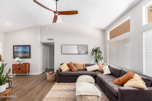 living room with hardwood / wood-style floors, ceiling fan, and high vaulted ceiling