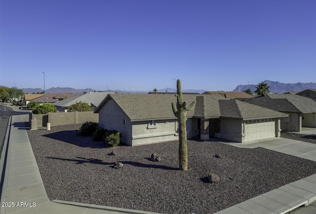 view of front of home featuring a garage and a mountain view