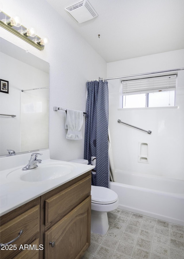 full bathroom with vanity, shower / tub combo with curtain, and toilet