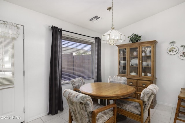 dining room featuring light tile patterned flooring and an inviting chandelier