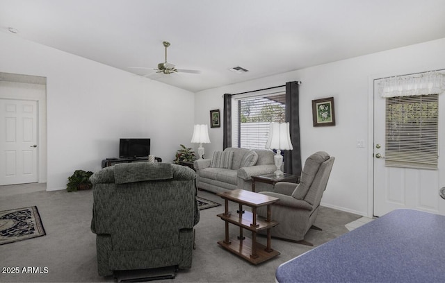 living room featuring ceiling fan, vaulted ceiling, and light carpet