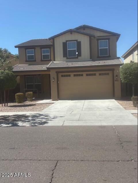 10335 W Pima St, Tolleson, AZ 85353 - view of front of house with a garage and concrete driveway
