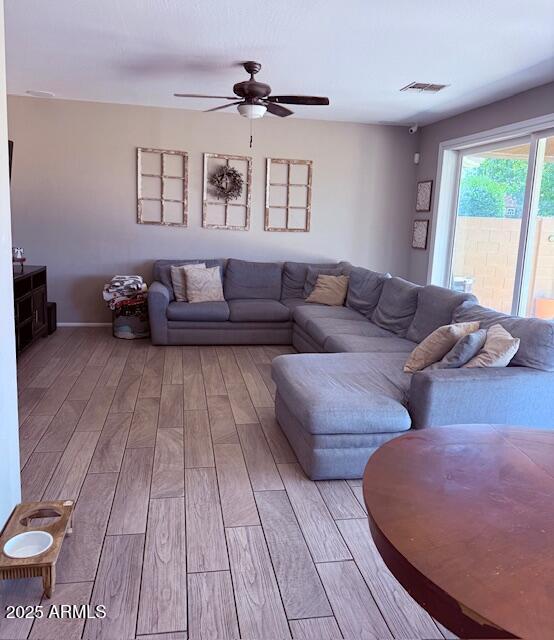 10335 W Pima St, Tolleson, AZ 85353 - living area with wood finished floors and ceiling fan