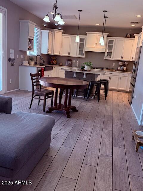 10335 W Pima St, Tolleson, AZ 85353 - dining room featuring light wood-style flooring, a chandelier, and recessed lighting