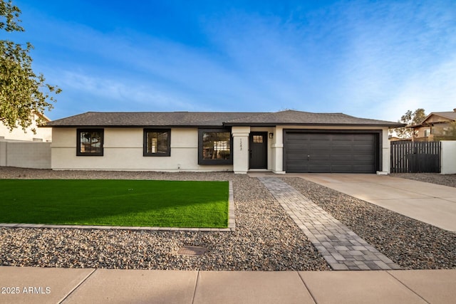 ranch-style house with a garage and a front yard