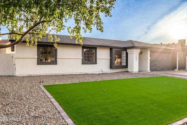 ranch-style home with a front yard and a garage