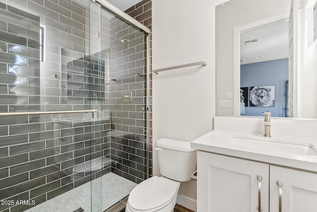 full bath with toilet, visible vents, a shower stall, and vanity